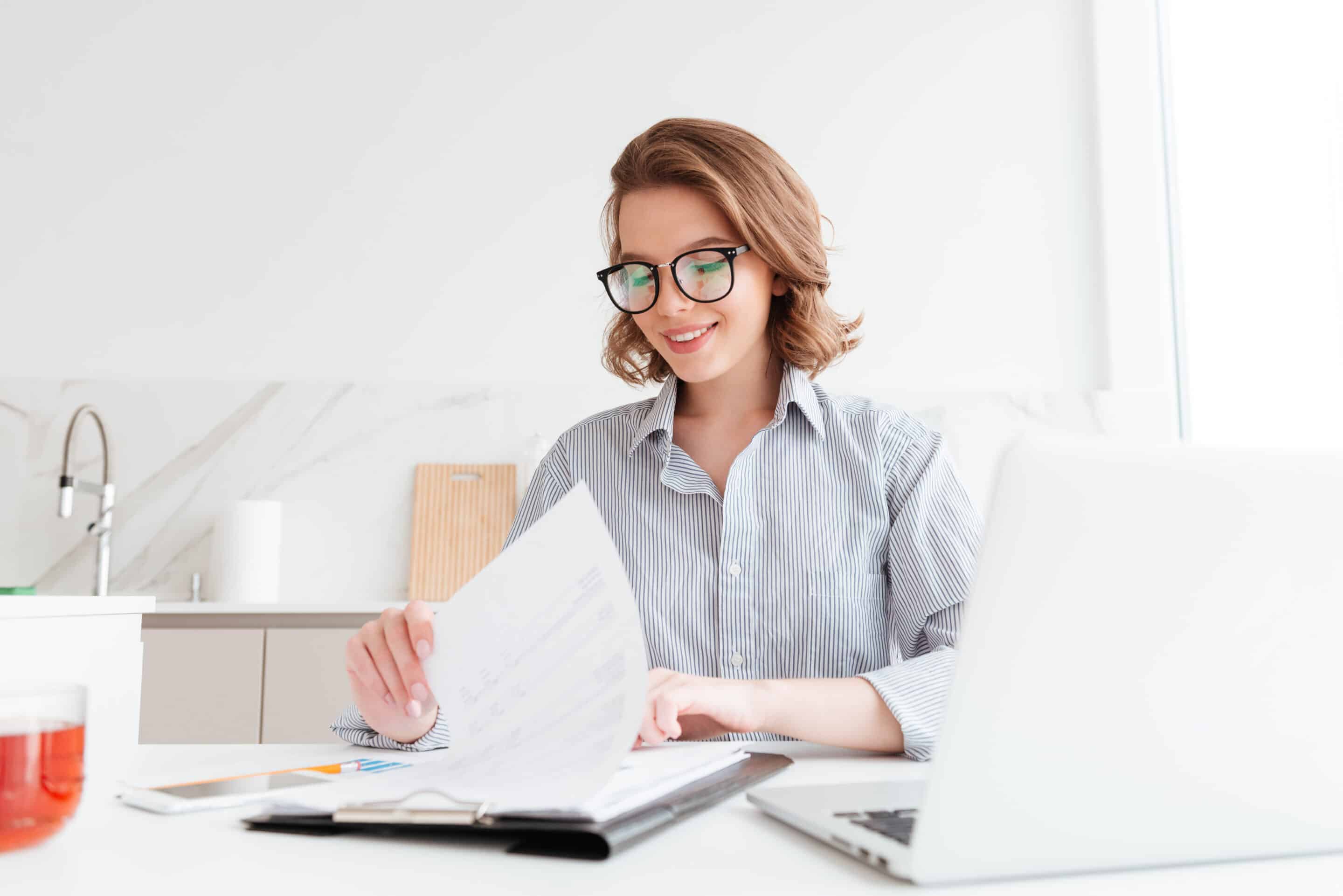 photo of cheerful attractive woman in glasses reading new contra